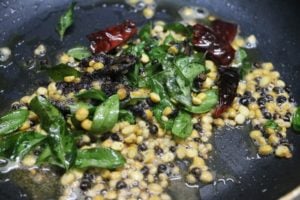 frying black peppercorns and lentils for milagu kuzhambu