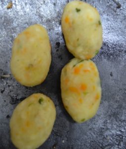 Shaping potato lollipops for frying