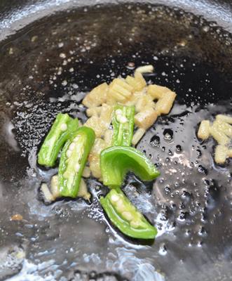 sauteing ginger-garlic and green chilies for chilli baby corn recipe