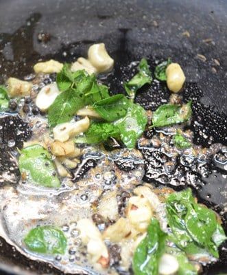 frying curry leaves and cashews