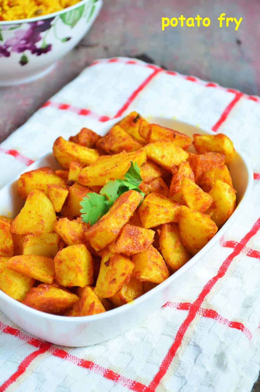 crispy potato fry or aloo fry in a ceramic dish