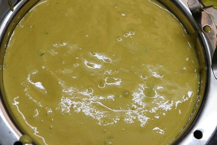 khaman batter poured in the greased pan