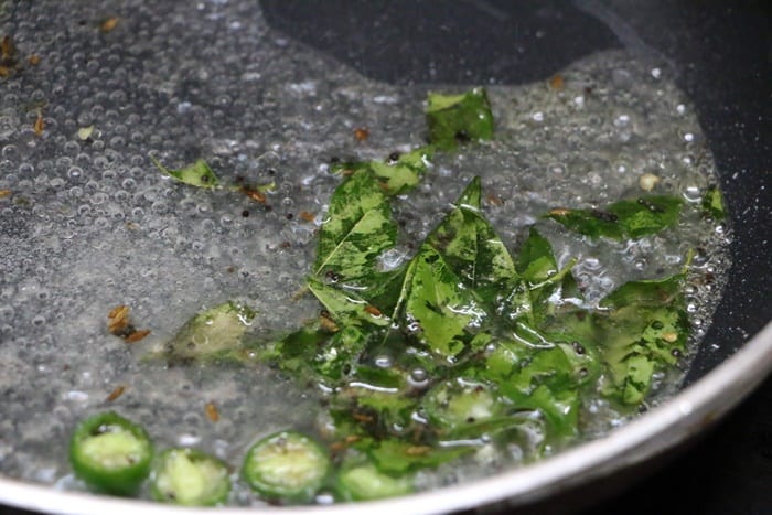 Adding water, sugar to dhokla