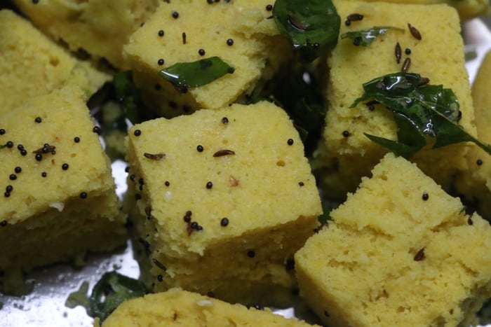 tempering poured over steamed and sliced khaman