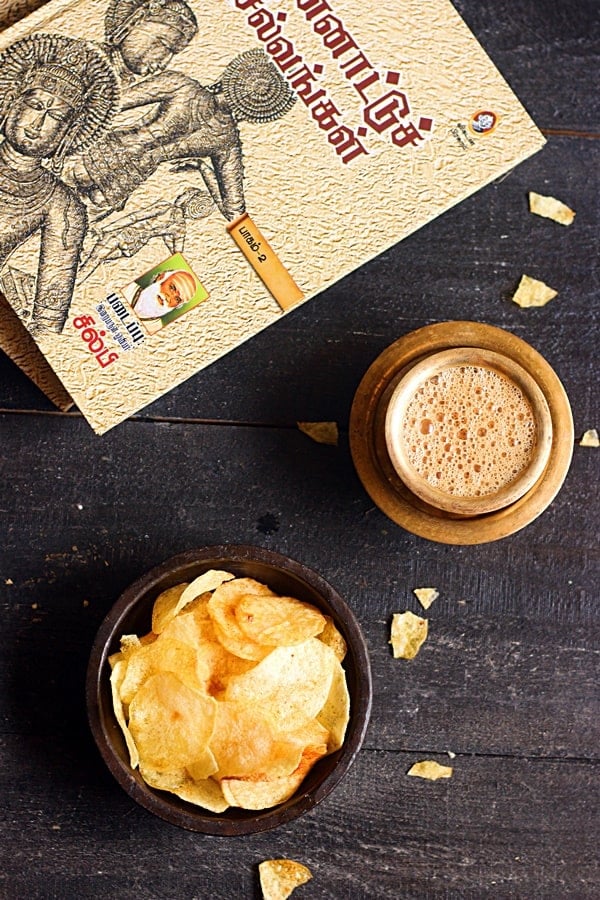 Crispy potato chips served with filter coffee. A book in the background.