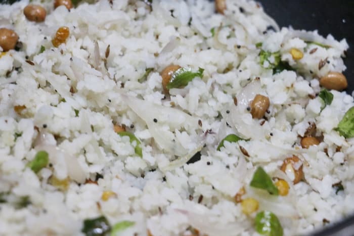 preparing onion poha recipe