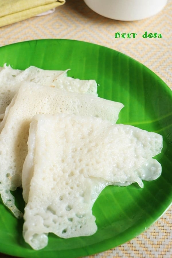 soft lacy neer dosa in a green ceramic plate