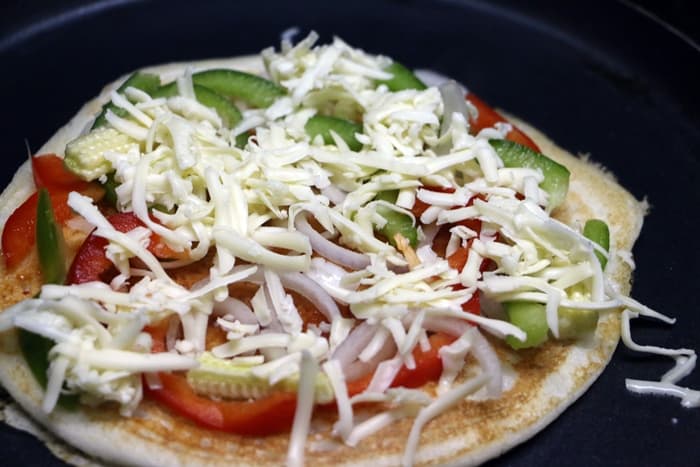 dosa pizza topped with cheese