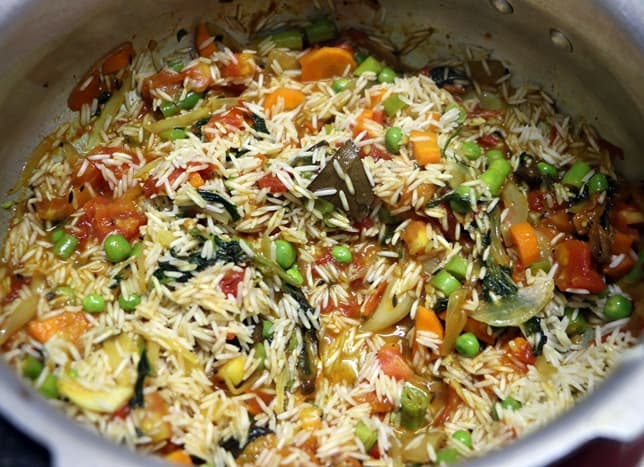 soaked and drained rice added to mixed vegetables
