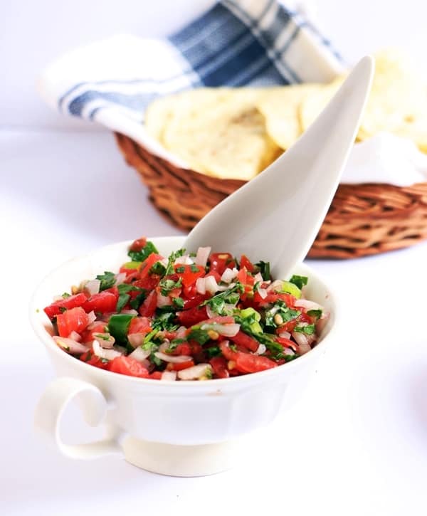 mexican tomato salsa in bowl with spoon