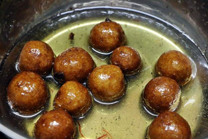 soaking bread gulab jamun in sugar syrup