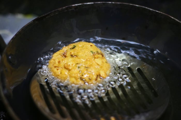 frying masala vada in hot oil