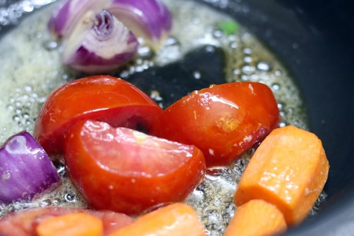 sauteing veggies for making carrot tomato soup recipe