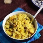 fresh kanda batata poha or aloo poha served in a ceramic bowl