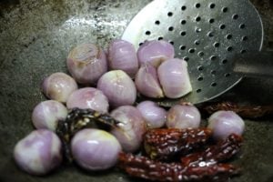 frying shallots in oil for making onion chutney