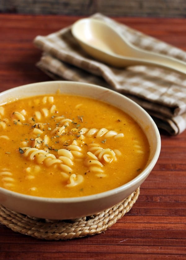 pasta soup served in a ceramic bowl.