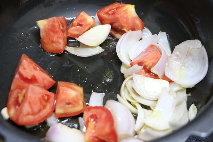 sautéing tomatoes with onion