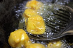 frying paneer pakora until crispy and golden,