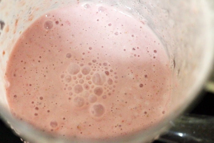strawberries and milk blended smooth for making milkshake