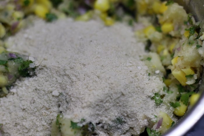 adding poha crumbs-making corn cutlet recipe