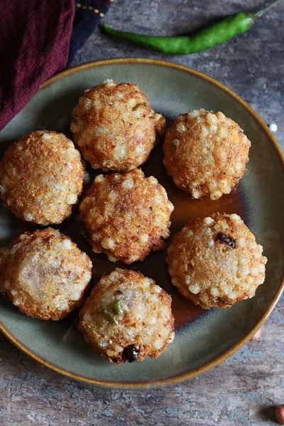 Sabudana vada is a popular deep fried snack from Maharastra. This vegan gluten free cutlet made of sago or tapioca pearls is popular snack for fasting days like Navratri. You can make these vadas in no time if you have soaked sago pearls ready. With just very few ingredients like potatoes, peanuts and sago this vada tastes so delicious and filling. Here is how to make best sabudana vada at home that does not break, is crispy and non greasy!