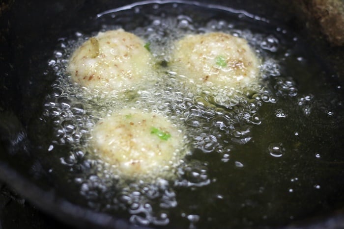 Deep frying sabudana vada in hot oil