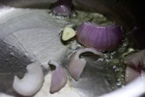 Sautéing onions and garlic in olive oil.