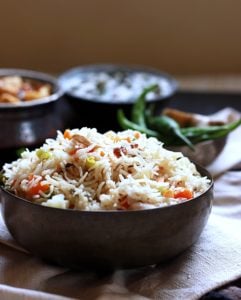 This veg pulao recipe is delicious, easy and gives you the perfect restaurant style veg pulao every single time. You can make this pilaf very easily for a crowd. With a chockablock of veggies and mild spices, this vegetable pulao will easi;y be the star of any feast!