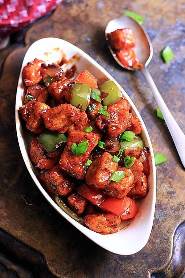 paneer chilli ready to serve in a oval ceramic white dish