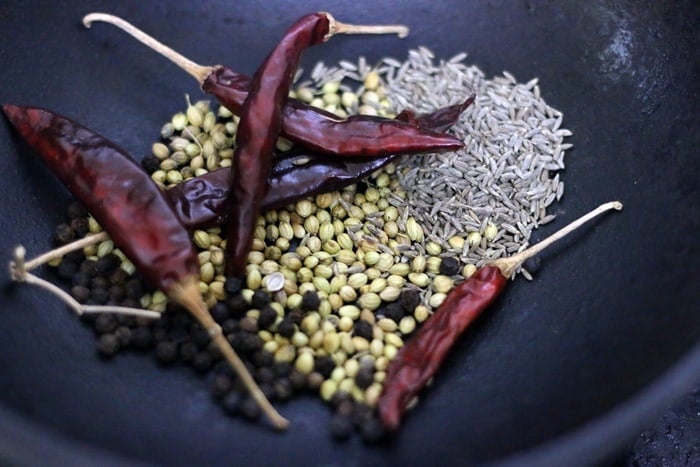 roasting whole spices -coriander seeds, dry red chilies, cumin seeds and black peppercorns for kadai masala