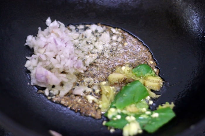 sautéing onion, ginger garlic and green chili in butter in a kadai 