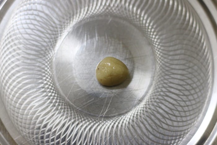 checking the consistency of kaju mixture by making small balls