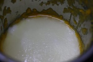 yogurt added to blended mangoes for lassi