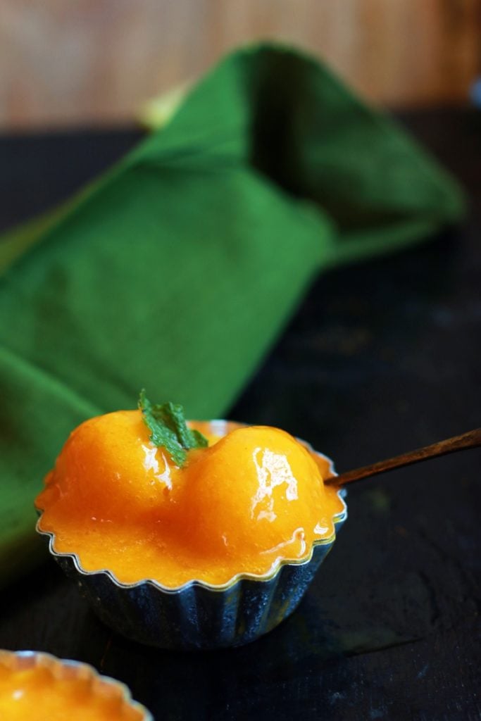 two scoops of homemade mango sorbet in a small bowl