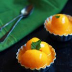 Homemade mango sorbet served in small bowls with a spoon