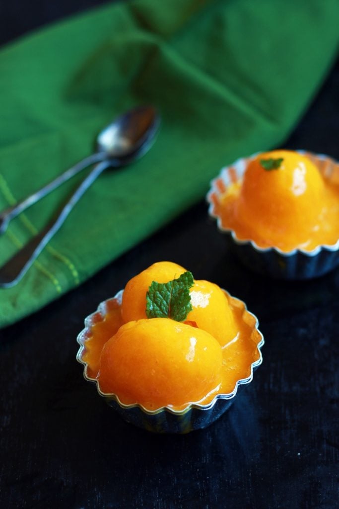 Homemade mango sorbet served in small bowls with a spoon