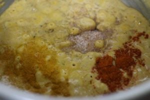 adding spice powders to korma paste