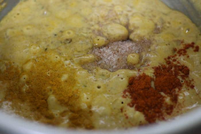 adding spice powders to korma paste