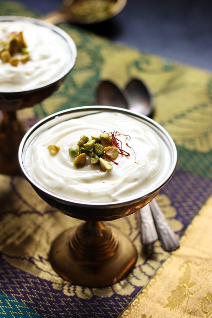 Fresh creamy homemade shrikhand served in two dessert bowls with spoons.