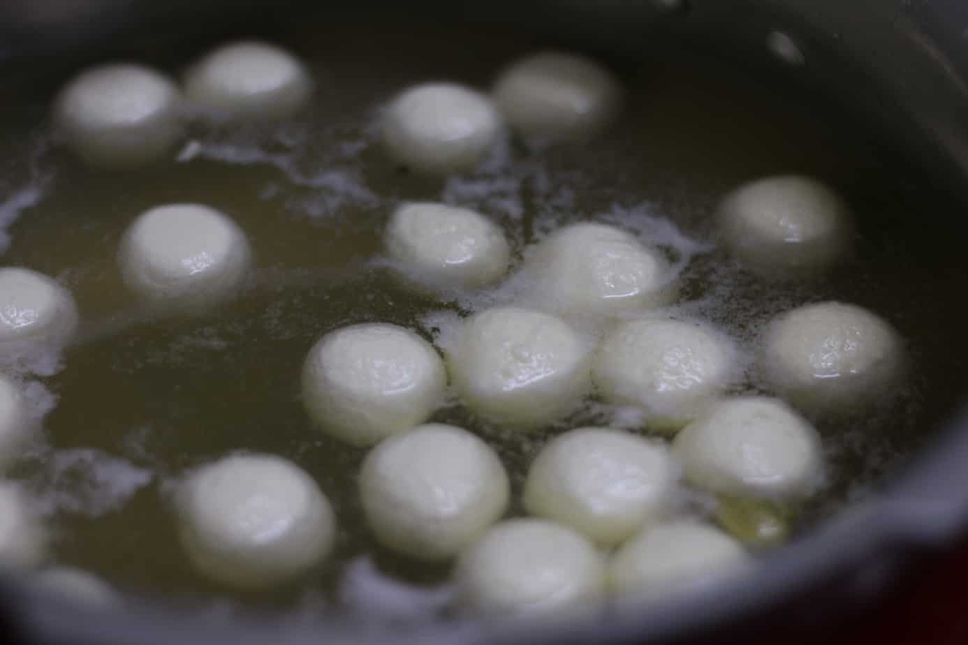 Boiling chenna balls in sugar syrup