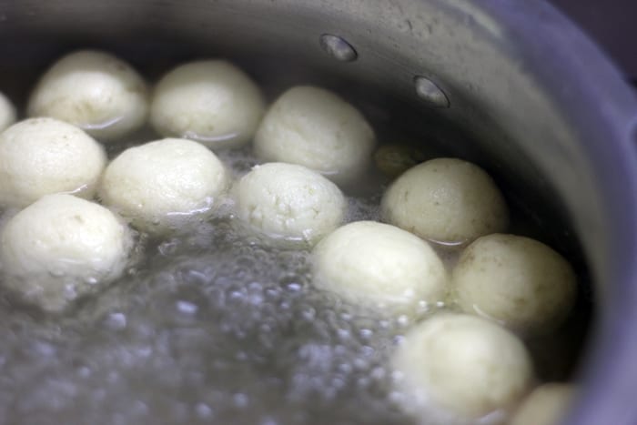 paneer balls boiling in sugar syrup