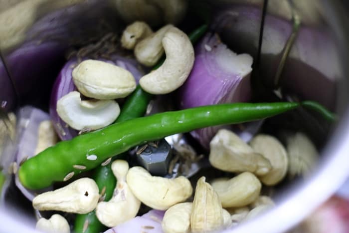 Onions, cashews, green chilies, ginger garlic and cumin in a mixer jar