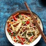 chilli garlic noodles served in a ceramic bowl with chopsticks