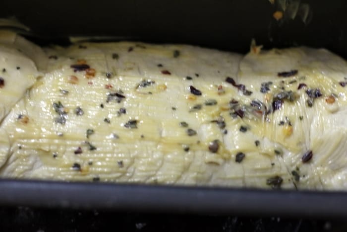 herb garlic bread dough shaped into loaf