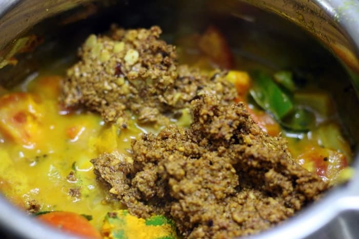 Adding sambar masala to the boiled masala