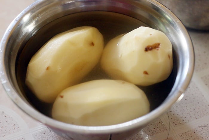 Peeled potatoes soaked in water