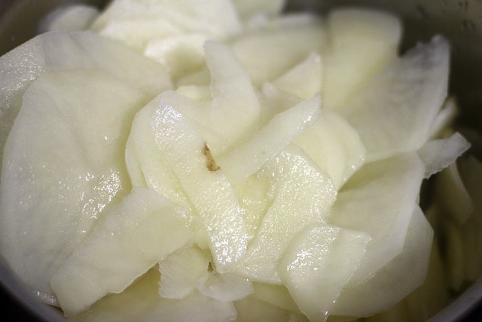 Excess water drained from sliced potatoes