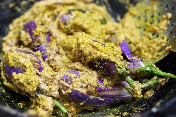 Preparing bharli vangi curry