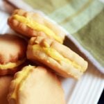 Closeup shot of homemade mango flavored custard creams in a white plate