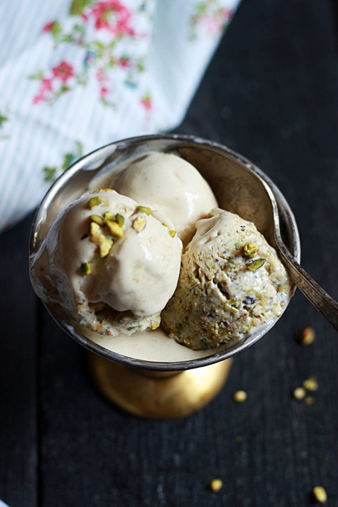 Overhead shot of no cook pistachio ice cream served with a spoon in copper ice cream bowl